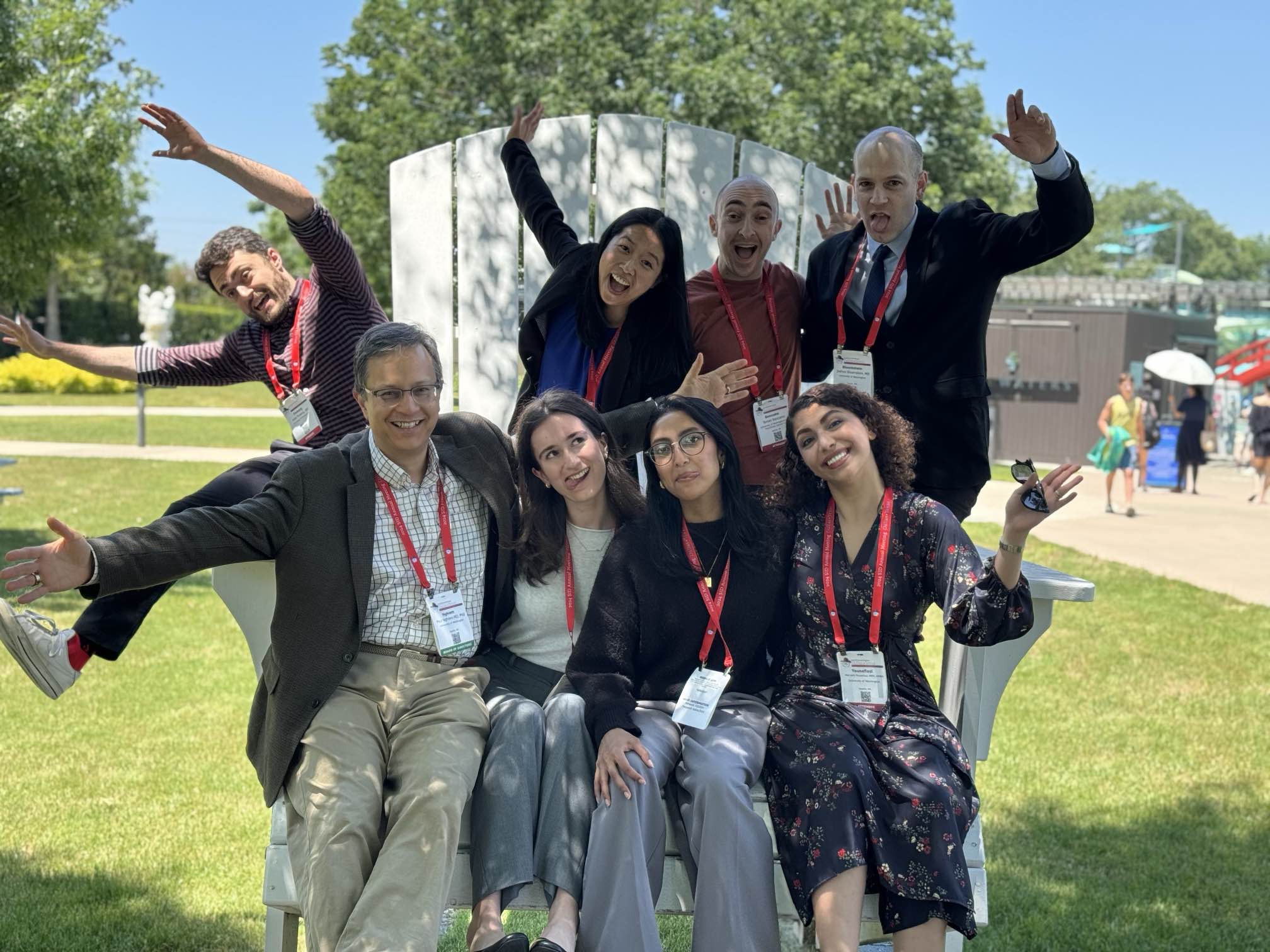 Dr. Nghiem and trainees on an oversized chair 