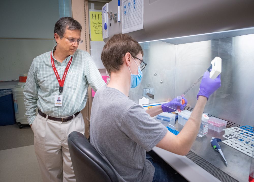 researcher working under fume hood