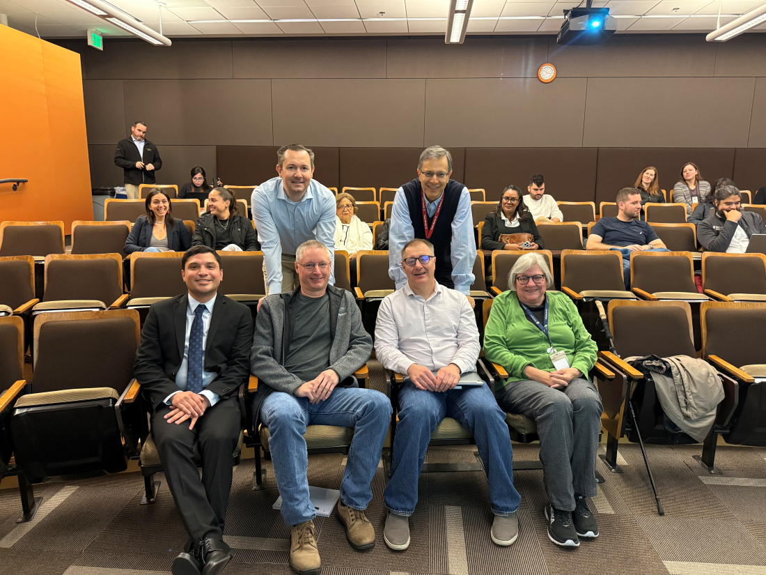 Haroldo with mentors in auditorium